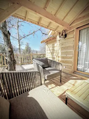 a porch with a bench and a chair on a deck at U Castellu di A Sulana in Casabianca