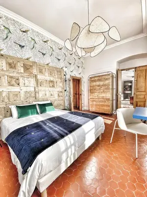 a bedroom with a large bed and a chair at U Castellu di A Sulana in Casabianca