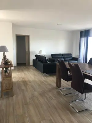 a living room with a black couch and a table at Mare e Monti in Aléria