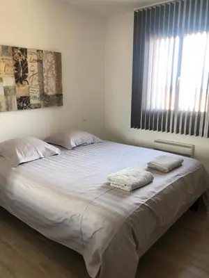 a bedroom with a large bed with two pillows on it at Mare e Monti in Aléria