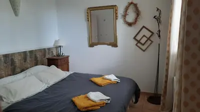a bedroom with a bed with two towels on it at un ecrin de verdure face à la mer in Isolaccio-di-Fiumorbo