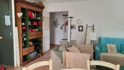 a living room with a couch and a chair at un ecrin de verdure face à la mer in Isolaccio-di-Fiumorbo