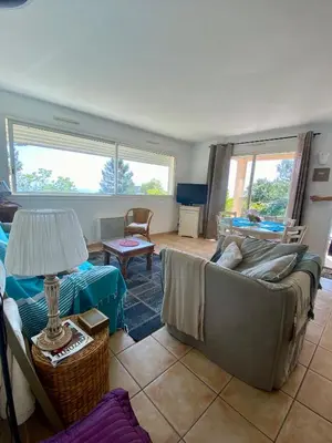 a living room with a couch and a table at un ecrin de verdure face à la mer in Isolaccio-di-Fiumorbo
