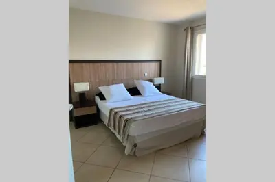 a bedroom with a large bed with white sheets and pillows at Salina Bay Porto Vecchio in Porto-Vecchio