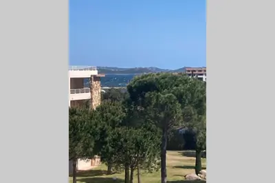 a view of a park with trees and a building at Salina Bay Porto Vecchio in Porto-Vecchio