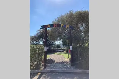 a gate with a sign that reads animal pdq at Salina Bay Porto Vecchio in Porto-Vecchio
