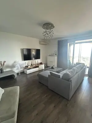 a large living room with a couch and a tv at Duplex F4-2 balcons face a la mer in Ajaccio