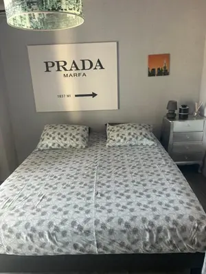 a bedroom with a bed and a sign on the wall at Duplex F4-2 balcons face a la mer in Ajaccio