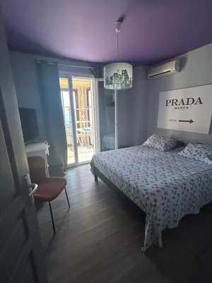 a bedroom with a bed and a purple ceiling at Duplex F4-2 balcons face a la mer in Ajaccio
