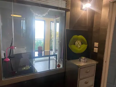 a room with a desk and a green pumpkin on the wall at Duplex F4-2 balcons face a la mer in Ajaccio