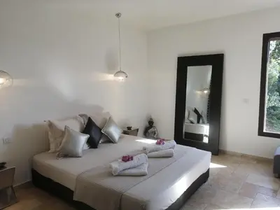 a bedroom with a large white bed with towels on it at A Muredda in Figari