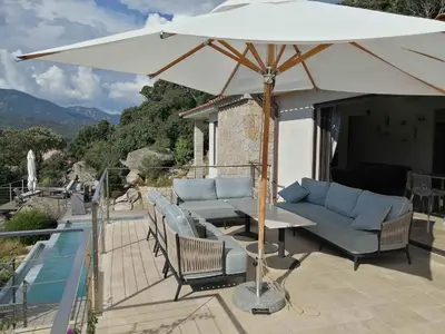 a white umbrella sitting on top of a patio at A Muredda in Figari