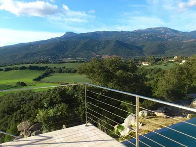 a view of the mountains from the balcony of a house at A Muredda in Figari