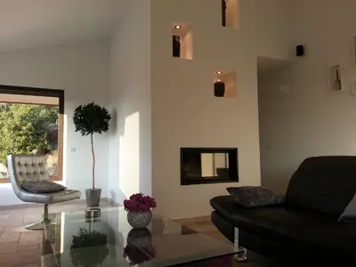 a living room with a couch and a glass table at A Muredda in Figari
