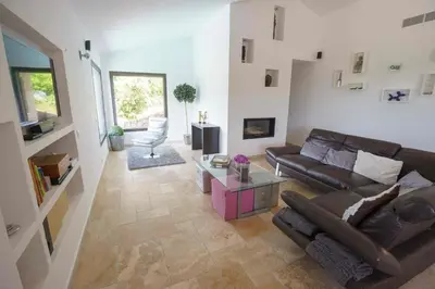 a living room with a couch and a table at A Muredda in Figari