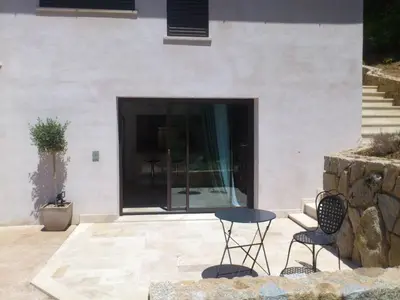two chairs and a table in front of a building at A Muredda in Figari