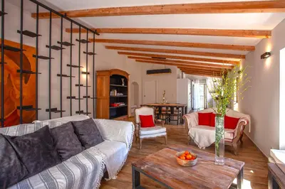 a living room with a couch and a table at Maison de Charme-A STALLA- Entre Mer et Montagne in Muro