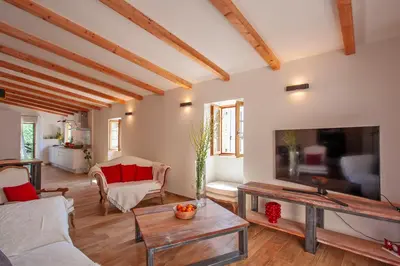 a living room with a large flat screen tv at Maison de Charme-A STALLA- Entre Mer et Montagne in Muro