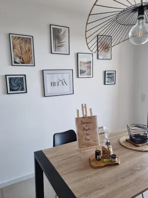 a dining room with a table with a fan on the wall at Agosta Sea View in Porticcio