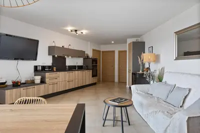 a living room with a couch and a tv at Agosta Sea View in Porticcio