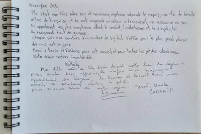 a notebook with a handwritten handwriting on it at Agosta Sea View in Porticcio