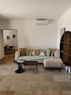 a living room with a couch and a table at Résidence Licciola in Propriano
