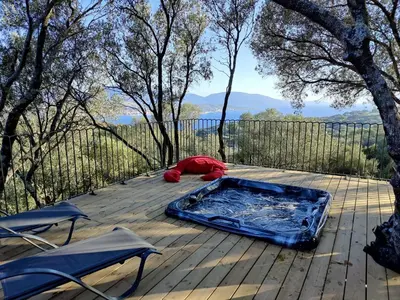 a hot tub sitting on top of a wooden deck at Résidence Licciola in Propriano