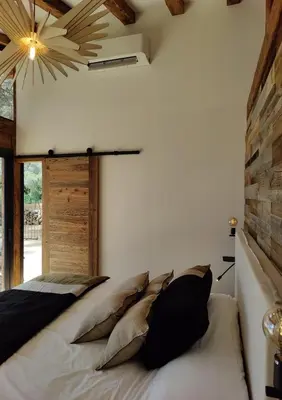 a bedroom with a large bed with pillows on it at Résidence Licciola in Propriano