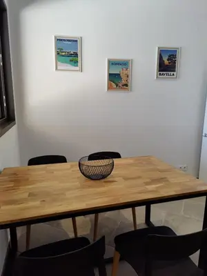 a wooden table with chairs in a room at Résidence Licciola in Propriano