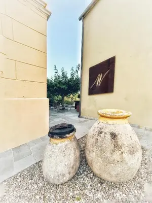 two large vases sitting next to a building at A Villa di Rutali in Rutali