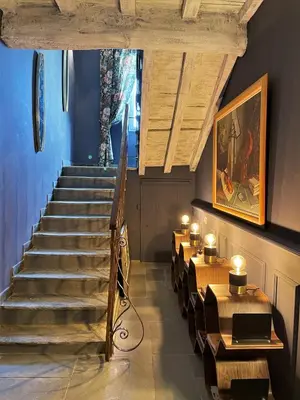 a staircase in a restaurant with tables and a stair case at A Villa di Rutali in Rutali