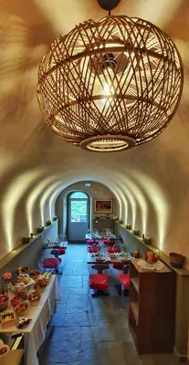 a dining room with tables and chairs and a large chandelier at A Villa di Rutali in Rutali