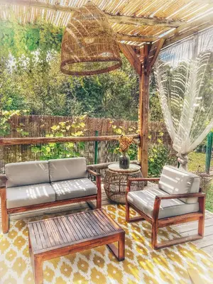 a patio with a couch and chairs and a pergola at A Villa di Rutali in Rutali