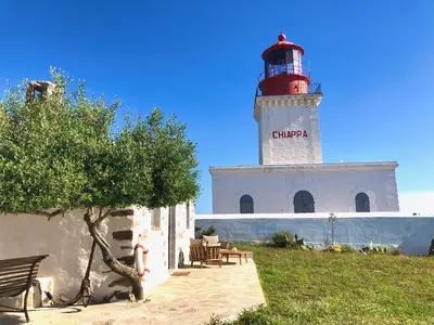 a red and white lighthouse on top of a building at La Chambre du Phare à Porto-Vecchio, unique ! in Porto-Vecchio