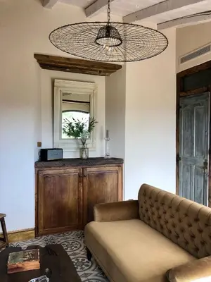 a living room with a couch and a table at La Chambre du Phare à Porto-Vecchio, unique ! in Porto-Vecchio