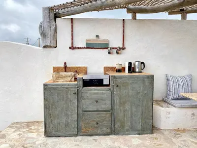 a wooden kitchen with a sink and a counter at La Chambre du Phare à Porto-Vecchio, unique ! in Porto-Vecchio