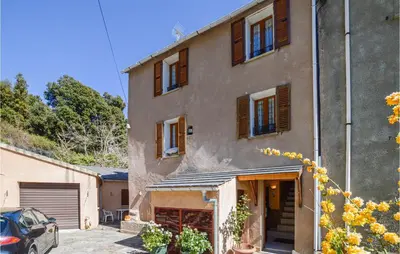 a large house with a car parked in front of it at Amazing Home In Morosaglia With Wifi in Morosaglia