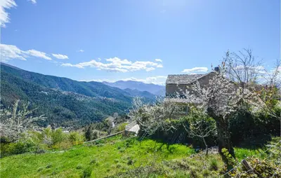 a house on a hill with mountains in the background at Amazing Home In Morosaglia With Wifi in Morosaglia