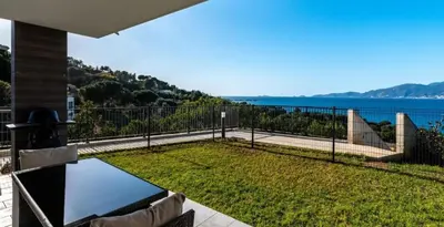 a balcony with a view of the water at Les Rivages de Stagnola Appartement T3 vue mer et montagne plage 200m climatisé in Pietrosella