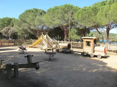 a park with a playground with a slide at Les Rivages de Stagnola Appartement T3 vue mer et montagne plage 200m climatisé in Pietrosella