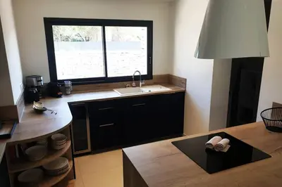 a kitchen with a sink and a window at Villa 5***** piscine proche de la plage Cala Rossa in Lecci