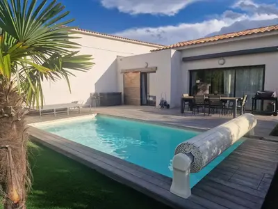 a pool with a water slide in front of a house at Villa 5***** piscine proche de la plage Cala Rossa in Lecci