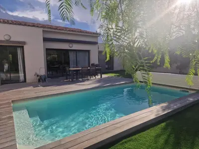 a swimming pool in front of a house at Villa 5***** piscine proche de la plage Cala Rossa in Lecci