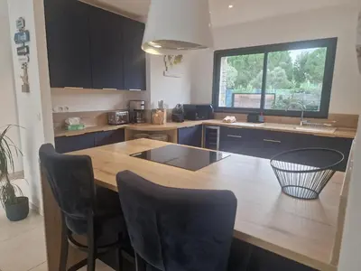 a kitchen with a wooden counter top and a sink at Villa 5***** piscine proche de la plage Cala Rossa in Lecci