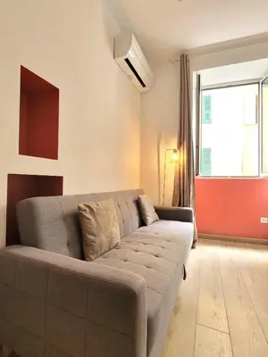 a large bed in a room with avertisementatronatronstrationstrationstration at Studio entièrement rénové vieille ville in Ajaccio