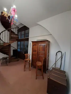 a room with a staircase and chairs and a stair case at F3 FENETRE SUR JARDIN VUE MER ET MONTAGNE pour 4 VOYAGEURS in Ajaccio