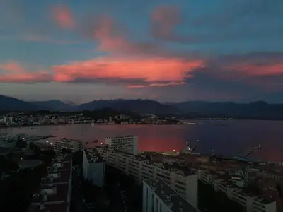 a view of a city with a large body of water at F3 FENETRE SUR JARDIN VUE MER ET MONTAGNE pour 4 VOYAGEURS in Ajaccio