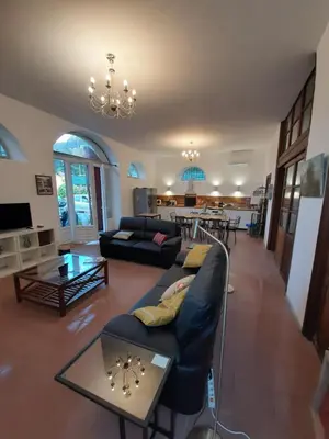 a living room with a couch and a table at F3 FENETRE SUR JARDIN VUE MER ET MONTAGNE pour 4 VOYAGEURS in Ajaccio