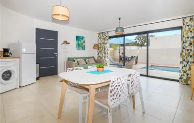 a kitchen and dining room with a table and chairs at Cala Di Mare in Lecci