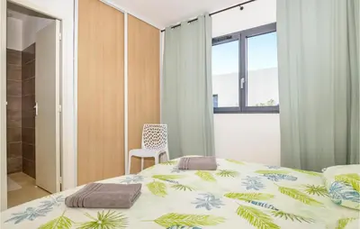 a bedroom with a bed and a chair and a window at Cala Di Mare in Lecci